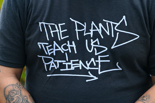 Black t-shirt with white text and arrow design that reads